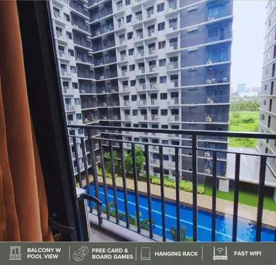 a balcony with a view of a large building at Shore Residences - Near Mall of Asia in Manila