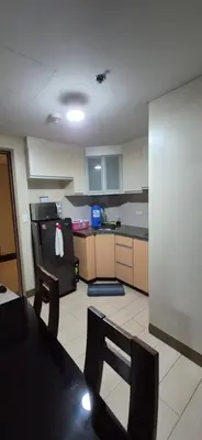 a kitchen with a table and chairs and a stove at Rqui Condotel Across Terminal 3 in Manila