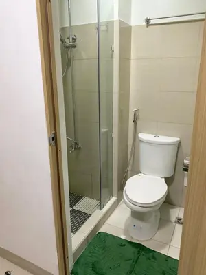 a bathroom with a toilet and a glass shower at Olivia in Manila