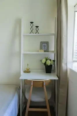 a desk with flowers on it in a bedroom at Elegant and Modern 2 BR Home Golf Skyline View in Manila