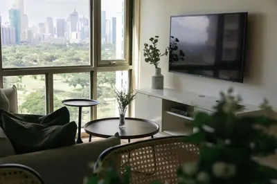 a living room with a couch and a tv at Elegant and Modern 2 BR Home Golf Skyline View in Manila