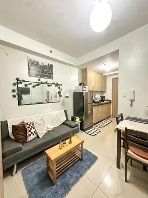 a living room with a couch and a table at The Hideout Condotel in Shore 2 Residences Tower 3 in Manila