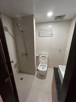 a bathroom with a toilet and a sink at Bayport West Naia Residences in Manila