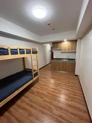 a room with two bunk beds and a kitchen at Bayport West Naia Residences in Manila