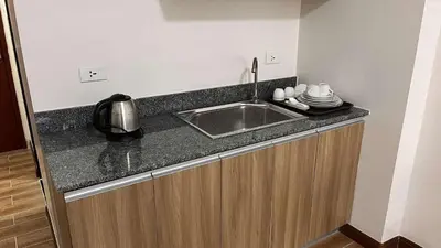 a kitchen with a sink and a counter top at Bayport West Naia Residences in Manila
