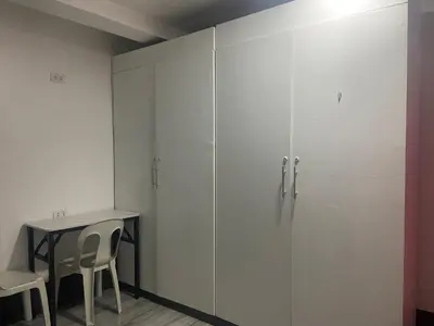 a room with a glass partition with a table and chairs at Marites Guesthouse in General Trias