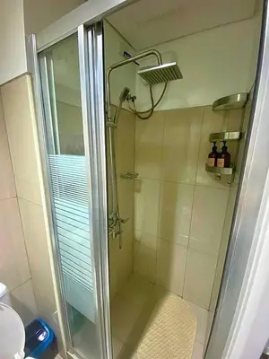 a shower with a glass door in a bathroom at Azure Staycation - Pablo's Suites in Manila