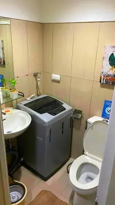 a small bathroom with a sink and a toilet at Azure Staycation - Pablo's Suites in Manila