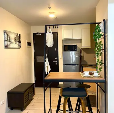 a kitchen with a table and two chairs in a room at Azure Staycation - Pablo's Suites in Manila