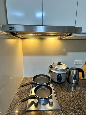 two pots and pans on a stove in a kitchen at Cozy Haven - Newport - Walking distance to NAIA T3 in Sampong