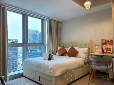 a bedroom with a bed with a view of a city at Luxurious & Elegant Unit in Parksuites BGC in Manila