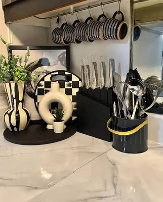 a kitchen counter with utensils and utensils at The Monochrome Nest in Manila