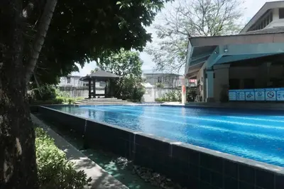 a swimming pool in front of a building at The Monochrome Nest in Manila