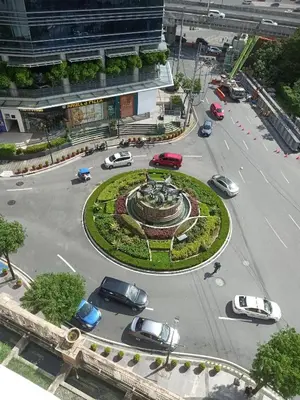 a roundabout with cars parked in a parking lot at 150 Newport Boulevard in Manila