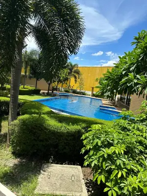 a large swimming pool with trees and a building at The Hive Condo Staycation Condo at Taytay Rizal in Taytay