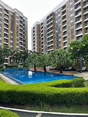 a swimming pool in front of some apartment buildings at The Hive Condo Staycation Condo at Taytay Rizal in Taytay
