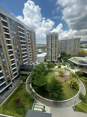 a park in the middle of a city with tall buildings at The Hive Condo Staycation Condo at Taytay Rizal in Taytay
