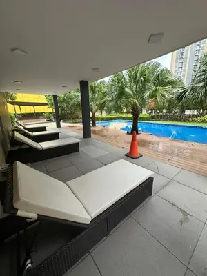 a room with two beds and a swimming pool at The Hive Condo Staycation Condo at Taytay Rizal in Taytay