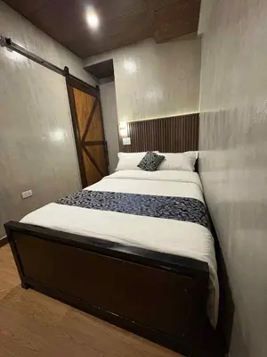 a bedroom with a large bed in a room at HM Eco Hotel NAIA in Manila