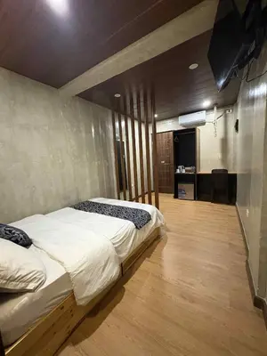 a bedroom with a bed and a television in it at HM Eco Hotel NAIA in Manila