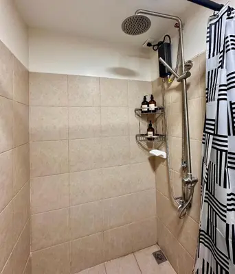 a bathroom with a shower with a shower curtain at South Breeze Stay Near Nuvali, Enchanted kingdom, Tagaytay in Silang