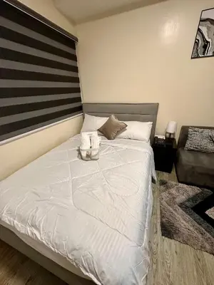 a bedroom with a bed with a american flag on it at South Breeze Stay Near Nuvali, Enchanted kingdom, Tagaytay in Silang