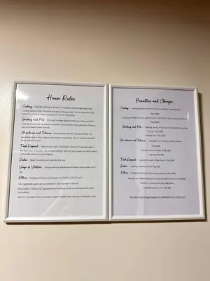 two white menus are hanging on a wall at South Breeze Stay Near Nuvali, Enchanted kingdom, Tagaytay in Silang