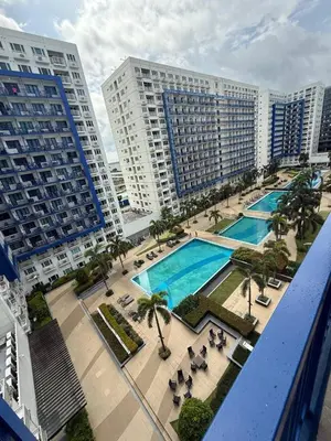 an aerial view of a swimming pool with buildings at Sea Residences Affordable Staycation Near MOA - by Rose in Manila
