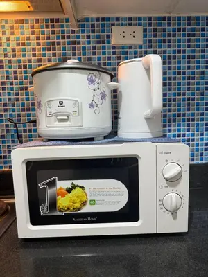 a microwave with a picture of food on top of it at Sea Residences Affordable Staycation Near MOA - by Rose in Manila