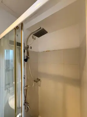 a bathroom with a shower with a glass door at Sea Residences Affordable Staycation Near MOA - by Rose in Manila