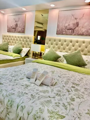 a bedroom with a bed with two books on it at 1BR Bahamas 19th floor, Azure Paraaque in Manila