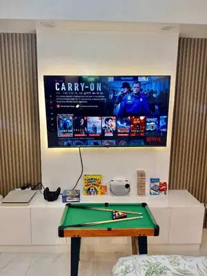 a ping pong table in a room with avertisement at 1BR Bahamas 19th floor, Azure Paraaque in Manila
