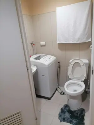 a small bathroom with a toilet and a sink at Location perfect staycation with Netflix in Manila