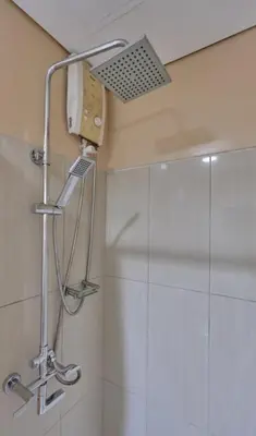 a shower with a shower head in a bathroom at Location perfect staycation with Netflix in Manila