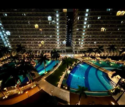 a view of a large building with a large swimming pool at Location perfect staycation with Netflix in Manila