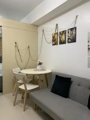 a living room with a couch and a table at Sea Residences by Estelle in Manila