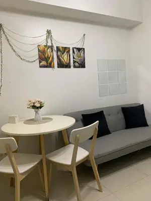 a living room with a table and a couch at Sea Residences by Estelle in Manila