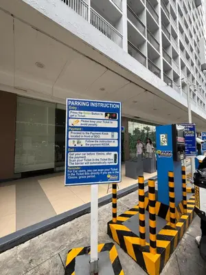 a sign in front of a building at Biens Staycation at SHORE Residences near Mall of Asia in Manila