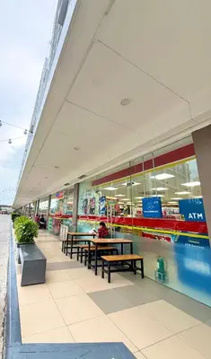 a shopping mall with tables and benches in it at Biens Staycation at SHORE Residences near Mall of Asia in Manila