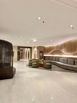 a lobby with couches and chairs in a building at Biens Staycation at SHORE Residences near Mall of Asia in Manila