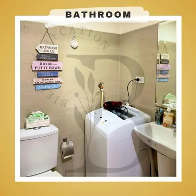 a bathroom with a toilet and a sink and a mirror at Biens Staycation at SHORE Residences near Mall of Asia in Manila