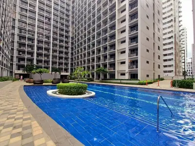 a swimming pool in front of two tall buildings at Classy Spacious flat Shore2 Mall of Asia Pasay in Manila
