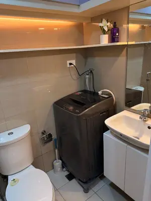a bathroom with a toilet and a sink at Classy Spacious flat Shore2 Mall of Asia Pasay in Manila