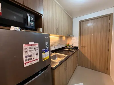 a kitchen with a stainless steel refrigerator and a sink at Classy Spacious flat Shore2 Mall of Asia Pasay in Manila