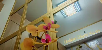 a vase with flowers on the wall of a building at Golden Shore Haven - Pasay in Manila