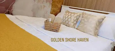 a bed with a basket on top of it at Golden Shore Haven - Pasay in Manila