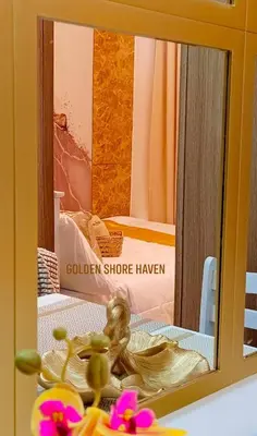 a mirror with a reflection of a bed in a room at Golden Shore Haven - Pasay in Manila