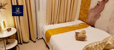 a hotel room with a bed with a sign on it at Golden Shore Haven - Pasay in Manila
