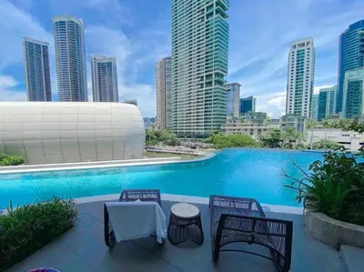 a swimming pool with a view of a city skyline at Novotel Hotel Residences at Acqua- AMOREsuite in Manila