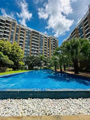 a large swimming pool in front of some buildings at Tower C 3rd Floor in Taytay